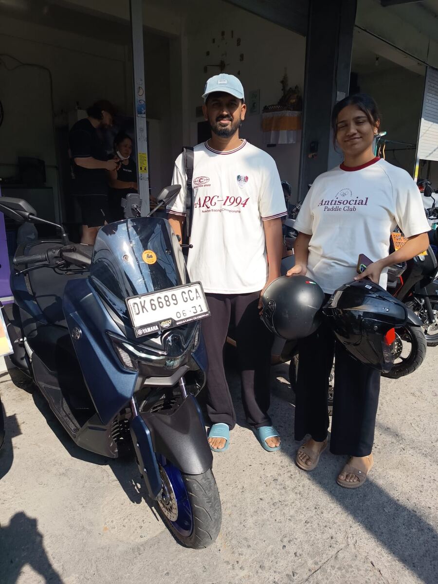 Two riders picking up a Yamaha NMAX